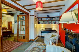 a living room with a couch and a piano at 3 Bed in Hawes oc-hhmy23 in Hawes