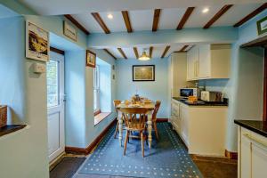 a kitchen with a table and chairs in a room at 3 Bed in Hawes oc-hhmy23 in Hawes +9 photos