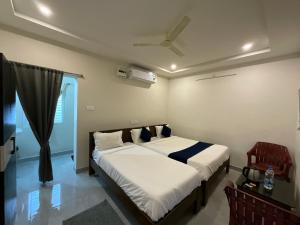 a bedroom with a bed and a window at MGR RESIDENCY in Srikalahasti