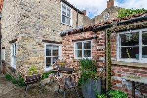 a brick house with chairs and a grill outside at 2 Bed in Pickering oc-y110 in Pickering