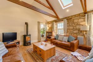 a living room with a couch and a tv at 3 Bed in Warkworth oc-nb400 in Warkworth