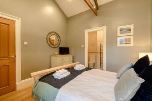 a bedroom with a large bed with towels on it at 3 Bed in Warkworth oc-nb400 in Warkworth