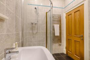 a bathroom with a shower and a tub and a sink at 3 Bed in Warkworth oc-nb400 in Warkworth +21 photos