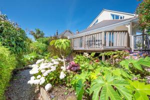 a garden in front of a house with flowers at 3 Bed in Fowey oc-p00755 in Fowey