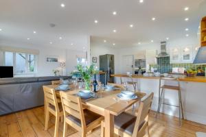 a kitchen and living room with a wooden table and chairs at 3 Bed in Fowey oc-p00755 in Fowey