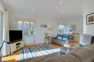 a living room with a couch and a flat screen tv at 3 Bed in Fowey oc-p00755 in Fowey