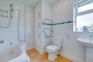 a white bathroom with a toilet and a sink at 3 Bed in Fowey oc-p00755 in Fowey +14 photos