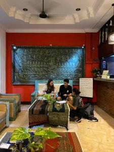 a group of people sitting around a table in a room at VPlus Hotel in Siem Reap