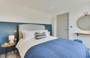 a blue and white bedroom with a large bed at 2 Bed in Padstow oc-p00876 in Padstow