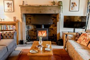 a living room with a couch and a fireplace at 4 Bed in Arkengarthdale oc-h27492 in Low Eskcleth