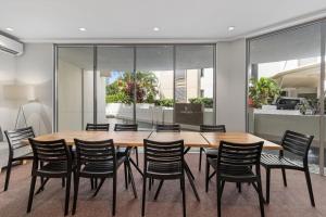 a conference room with a wooden table and chairs at Trilogy Surfers Paradise in Gold Coast