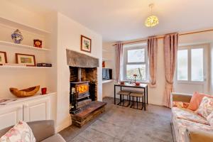 a living room with a couch and a fireplace at 2 Bed in Burtersett oc-g28336 in Hawes