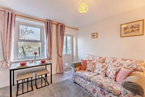 a living room with a couch and a table at 2 Bed in Burtersett oc-g28336 in Hawes