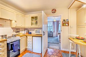 a kitchen with a white refrigerator and a counter at 2 Bed in Burtersett oc-g28336 in Hawes +6 photos