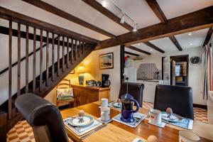 a dining room with a table and a staircase at 3 Bed in Brancaster oc-p28395 in Brancaster