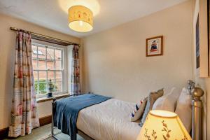 a bedroom with a bed and a window at 3 Bed in Brancaster oc-p28395 in Brancaster