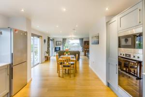 a kitchen and dining room with a table and chairs at 2 Bed in South Molton oc-willo in South Molton