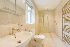 a white bathroom with a toilet and a sink at 2 Bed in South Molton oc-willo in South Molton +18 photos