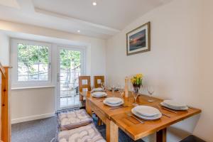 a dining room with a wooden table and chairs at 3 Bed in Aberdovey oc-v29263 in Aberdyfi +20 photos
