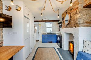 a kitchen with a stone fireplace and a sink at 2 Bed in Looe oc-a29612 in Looe +13 photos