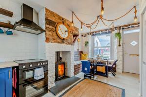 a kitchen with a stove and a dining room with a table at 2 Bed in Looe oc-a29612 in Looe