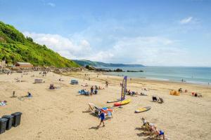 a group of people on a beach near the ocean at 2 Bed in Looe oc-a29612 in Looe