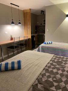 a room with two beds and a table and a kitchen at Punta Luna in La Serena +20 photos