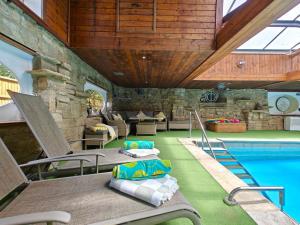 a pool room with a table and chairs and a swimming pool at 3 Bed in Timsbury oc-h29584 in Timsbury