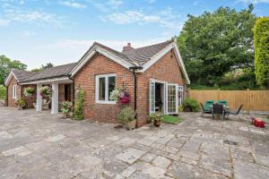 a brick house with a patio in front of it at 3 Bed in Timsbury oc-h29584 in Timsbury