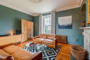 a living room with a couch and a chair at 5 Bed in Methwold oc-r29770 in Methwold