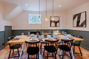 a dining room with a large wooden table and chairs at 5 Bed in Methwold oc-r29770 in Methwold