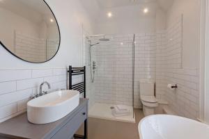 a white bathroom with a sink and a toilet at 5 Bed in Methwold oc-r29770 in Methwold +37 photos