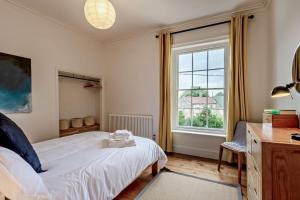 a bedroom with a bed and a large window at 5 Bed in Methwold oc-r29770 in Methwold