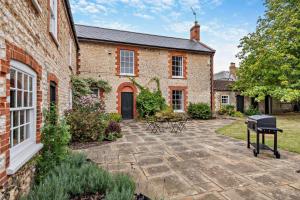 a courtyard of a brick house with a grill at 5 Bed in Methwold oc-r29770 in Methwold