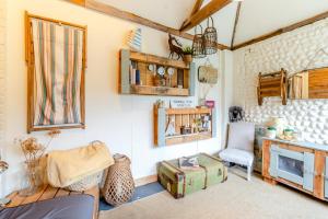 a living room with a couch a chair and a fireplace at 2 Bed in Bodham oc-s29720 in Bodham
