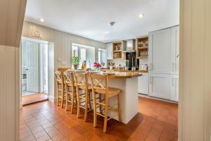 a kitchen with a island with bar stools at 2 Bed in Snettisham oc-t29559 in Snettisham