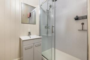 a white bathroom with a shower and a sink at 2 Bed in Snettisham oc-t29559 in Snettisham +15 photos