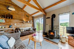 a living room with a couch and a fireplace at 1 Bed in Dre-Fach Felindre oc-a29876 in Felindre