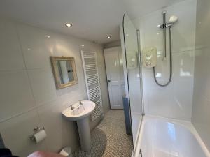 a bathroom with a sink and a shower and a toilet at 2 Bed in Hawes oc-b30521 in Hardraw +19 photos