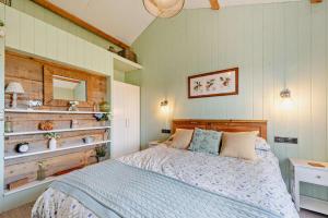 a bedroom with a bed with a wooden headboard at 1 Bed in Dre-Fach Felindre oc-a29876 in Felindre
