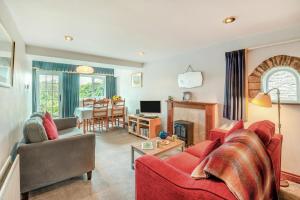 a living room with a red couch and a table at 3 Bed in Carperby oc-e30625 in Carperby