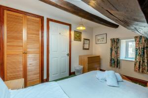 a bedroom with a white bed and a window at 3 Bed in Carperby oc-e30625 in Carperby