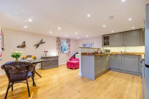 a kitchen and living room with a table and chairs at 1 Bed in Flimwell oc-s30131 in Ticehurst +11 photos