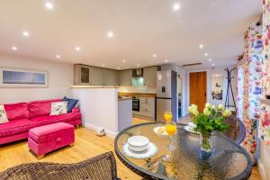 a living room with a red couch and a glass table at 1 Bed in Flimwell oc-s30131 in Ticehurst