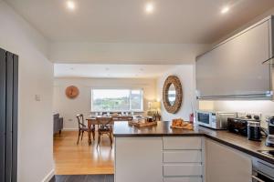 a kitchen and dining room with a table and chairs at 3 Bed in Aberdovey oc-n29124 in Aberdyfi