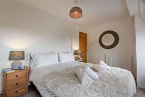 a bedroom with a large bed with white sheets and pillows at 3 Bed in Aberdovey oc-n29124 in Aberdyfi