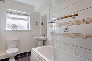 a white bathroom with a toilet and a sink at 3 Bed in Aberdovey oc-n29124 in Aberdyfi +16 photos