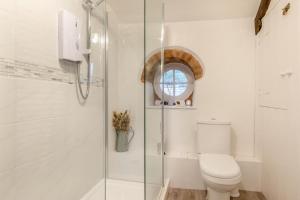 a bathroom with a toilet and a glass shower at 1 Bed in Dulverton oc-l30886 in Dulverton