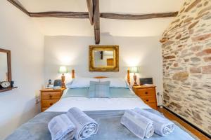 a bedroom with a bed and a stone wall at 1 Bed in Dulverton oc-l30886 in Dulverton