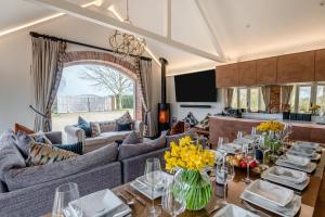 a living room with couches and a table with flowers on it at 5 Bed in Haceby oc-c31061 in Haceby